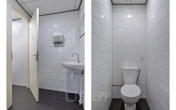 Kantoortoilet bij de Brauwweg 52-66 in Schiedam, voorzien van een toilet, wastafel en tegelwanden, geschikt voor gebruik tijdens kantoorruimte huren.
