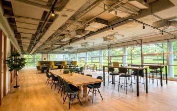 Ruime en lichte werkruimte met houten vloeren en moderne meubels op Boeing Avenue 1-19, perfect voor kantoorruimte huren in Schiphol Rijk.