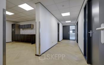 Moderne kantoorruimte met lichte houten vloer en geïntegreerde kitchenette op Fischerpad 106 in Sittard. Beschikbaar voor huur voor flexibele werkoplossingen.