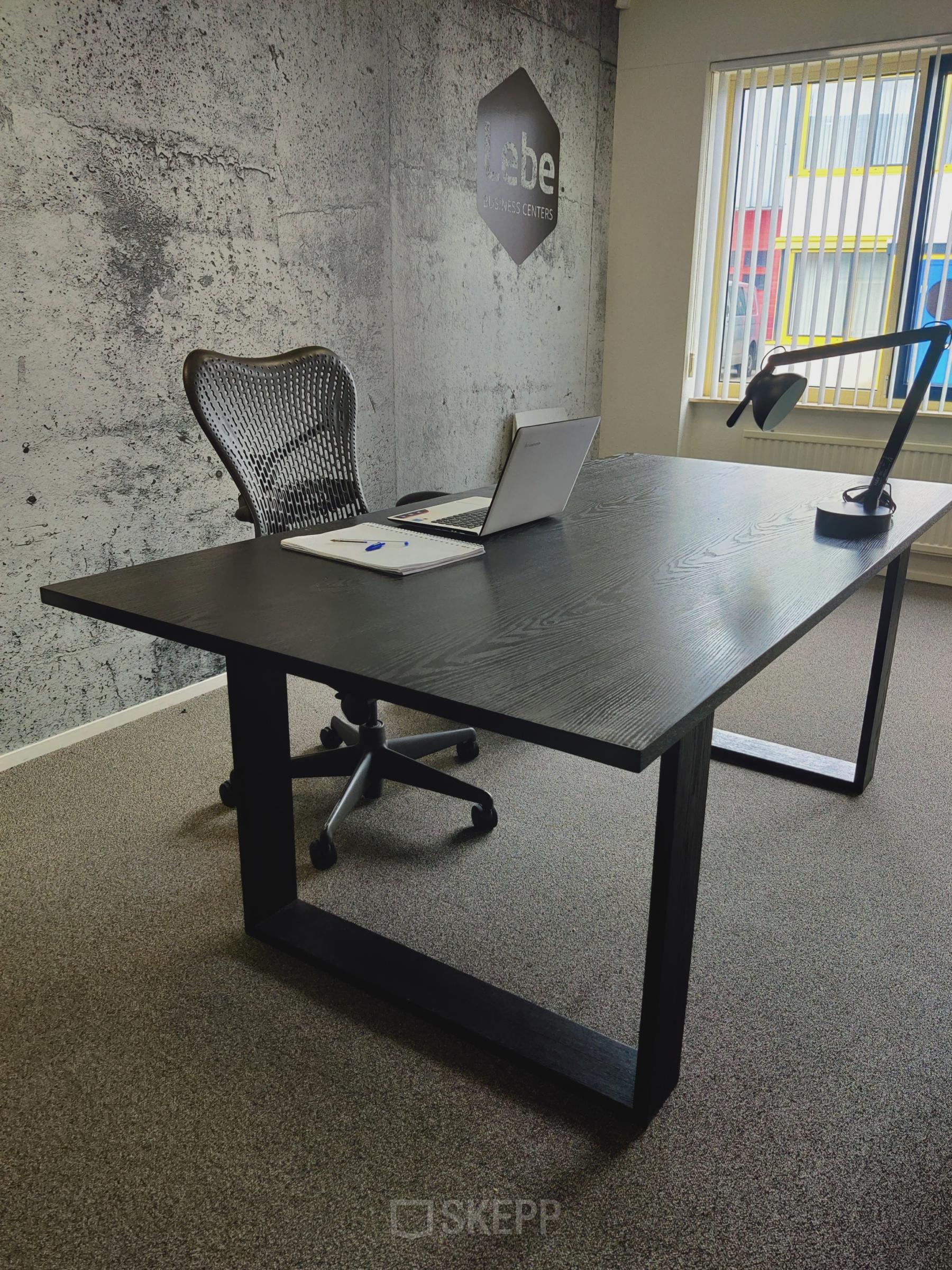 Modern kantoor te huur aan Dr. Nolenslaan 157 in Sittard, met een zwart bureau en ergonomische stoel.