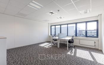office space with large windows two people