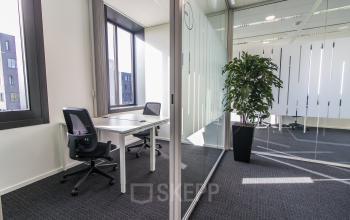 Moderne kantoorruimte te huur aan de Papendorpseweg 95-97 in Utrecht Papendorp, met glazen wanden, bureaus en stoelen. Ideaal kantoorpand voor flexwerkplekken of vergaderingen.