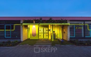 Exterieur van het kantoorpand op Vrieslantlaan 6 in Utrecht Zuid. Modern gevelontwerp met opvallende neonaccenten. Ideale locatie voor kantoorruimte huren in een zakelijke omgeving.