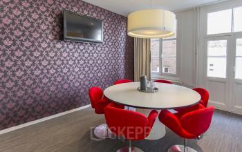 round table with red chairs light television
