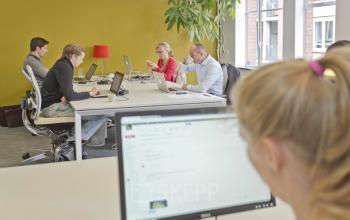 meeting room people screen yellow wall