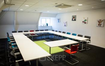 big meeting room for a lot of people colorful chairs