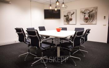 meeting room black chairs paintings cow television