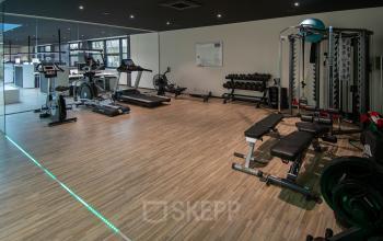 Kantoorruimte huren in Velp op Gildestraat 13 met een sportzaal, inclusief fitnessapparatuur zoals loopbanden en halters. Ideaal voor beweging tijdens werkpauzes.