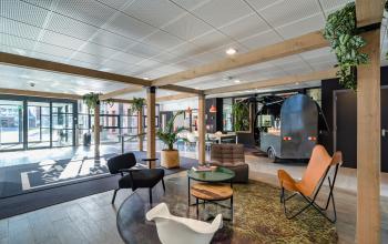 Moderne entree van kantoorpand Lange Dreef 10 in Vianen Utr, met stijlvolle zithoek en opvallende inrichting, ideaal voor bedrijven die kantoorruimte willen huren.