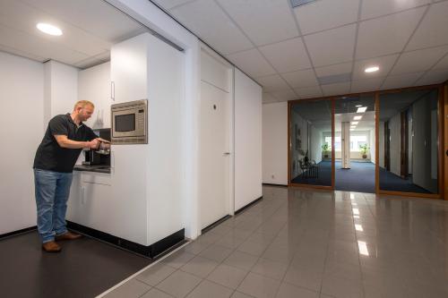 Kantoorpand aan Witboom 1 in Vianen Utr met man die koffie zet in een pantry. Zakelijke kantoorruimte huren met moderne voorzieningen.