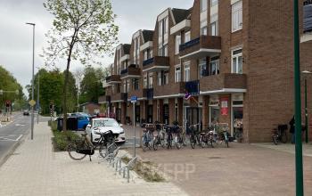 Exterieur van een kantoorpand aan de Boerendijk 8 in Woerden, met parkeerplaatsen en fietsenstalling voor de ingang.