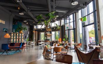 Modern ingerichte kantoorlounge met comfortabele zitplaatsen en plantendecoratie op Boerhaavelaan 40 in Zoetermeer, ideaal voor ontspanning of informele meetings.