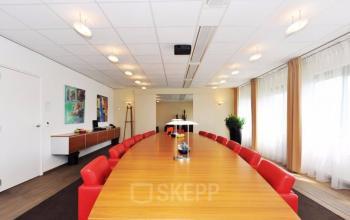 Meeting table with red chairs